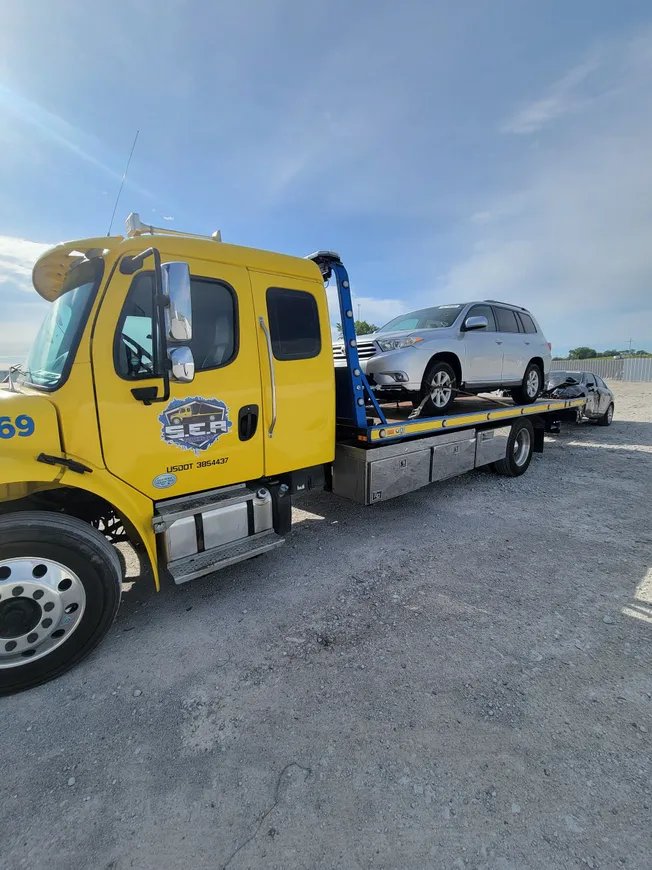 Yellow SEA Towing truck with SUV